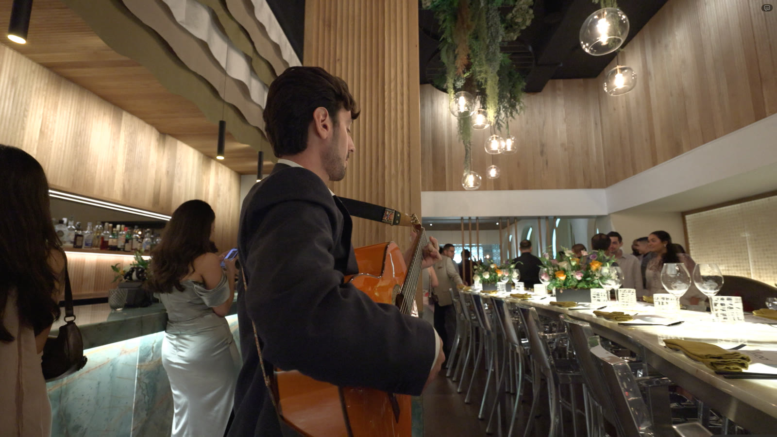 Sergio playing along a client dinner table