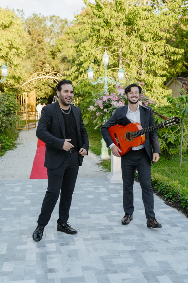 Sergio and a vocalist performing at a garden celebration