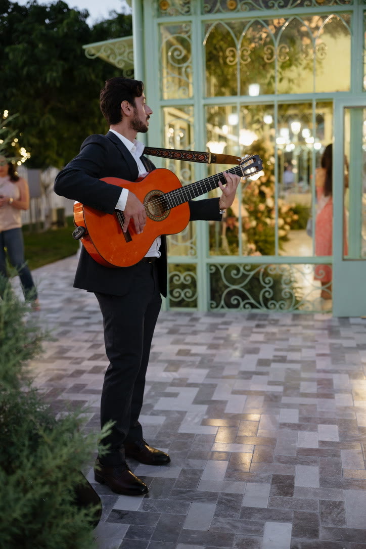 Sergio playing roaming Spanish guitar among guests